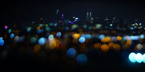 Defocused image of illuminated city at night