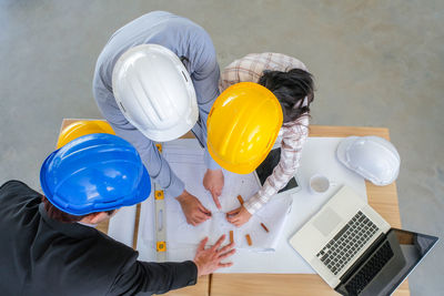 High angle view of people working on table