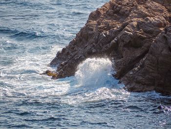 Sea waves splashing on rock