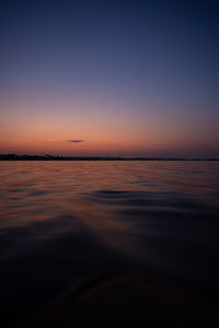 Scenic view of sea against clear sky at sunset