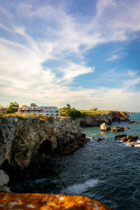 Scenic view of sea and cliffs against sky