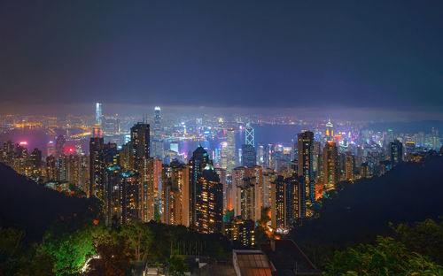 High angle view of illuminated city buildings against sky