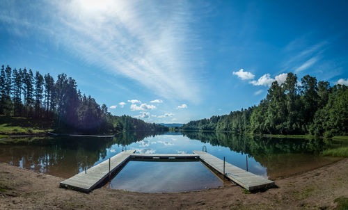 View of swimming pool in lake against cloudy sky