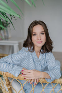 Portrait of a smiling young woman sitting outdoors