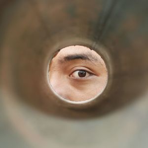 Portrait of mid adult man seen through hole