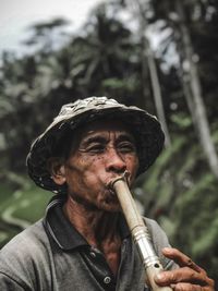 Close-up portrait of man smoking cigarette