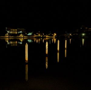 Reflection of illuminated lights in puddle