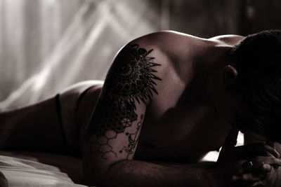 Portrait of young man lying on bed