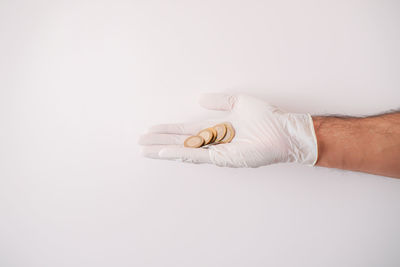 Close-up of hand holding white background