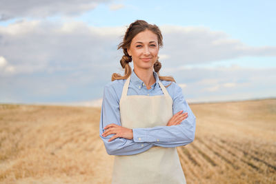 Portrait of smiling young man standing on field