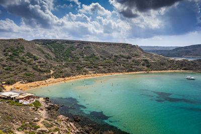 Scenic view of sea and mountains against sky