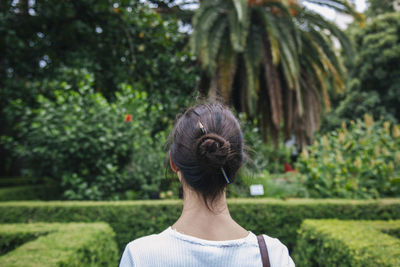 Rear view of woman against trees