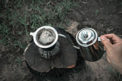 High angle view of hand holding coffee