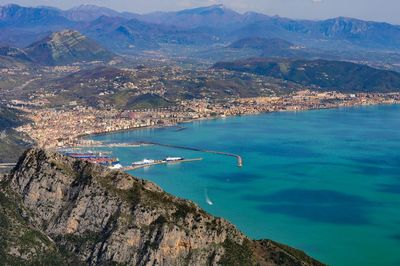 High angle view of sea and mountains against sky