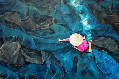 High angle view of woman working with fishing net