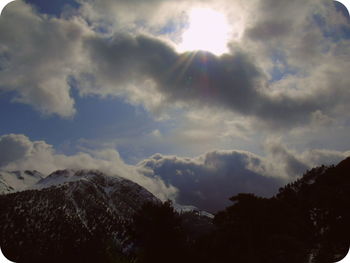 Low angle view of clouds over mountain