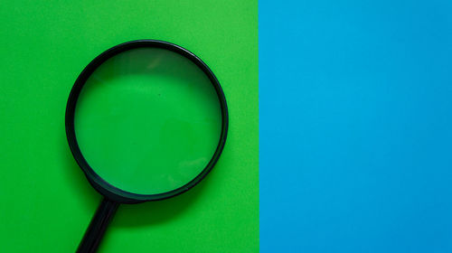 Close-up of blue glass against green background