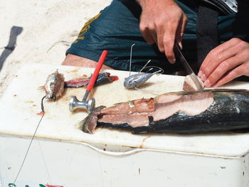 Midsection of person holding fish