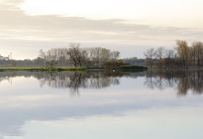 Scenic view of lake against sky at sunset