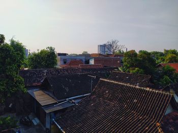High angle view of roof and buildings against sky