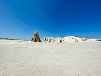 Scenic view of desert against blue sky