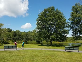 Men playing soccer on field against sky