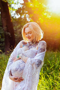 Pregnant of woman standing in forrest