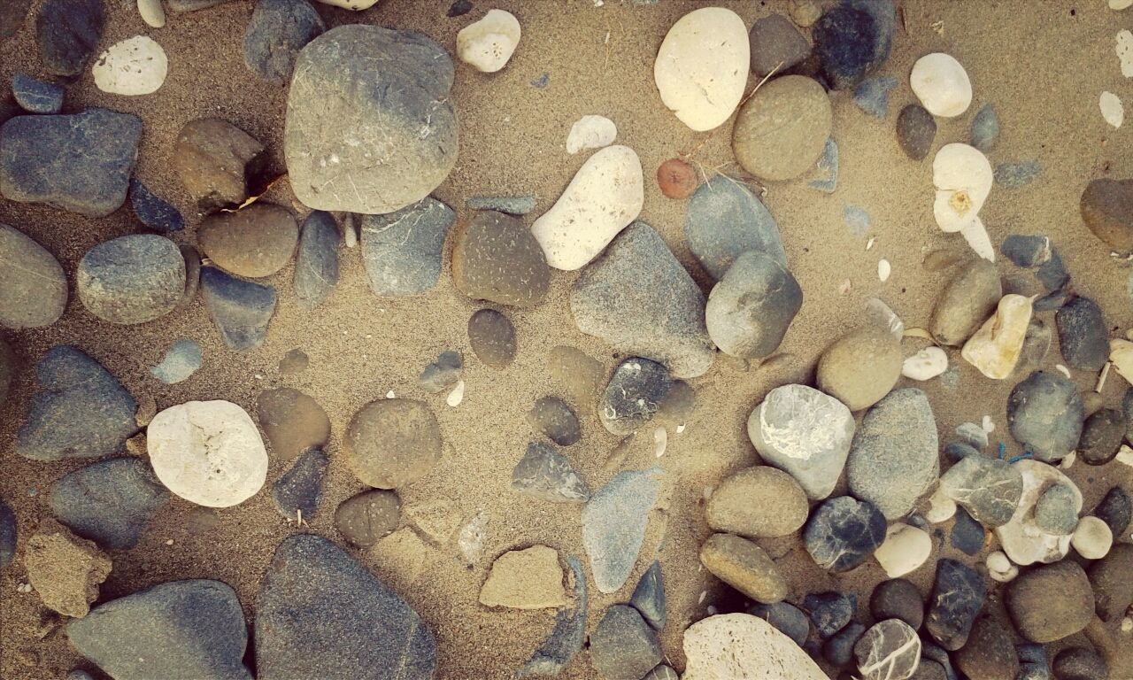 stone - object, pebble, high angle view, abundance, full frame, backgrounds, textured, large group of objects, beach, pattern, nature, rock - object, stone, outdoors, day, sunlight, sand, no people, natural pattern, cobblestone