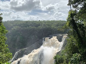 Scenic view of waterfall against sky