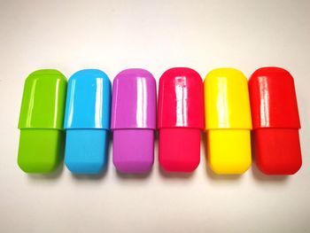 Close-up of colored pencils over white background