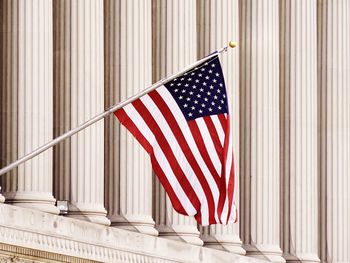 American flag hanging outside of the national archives building