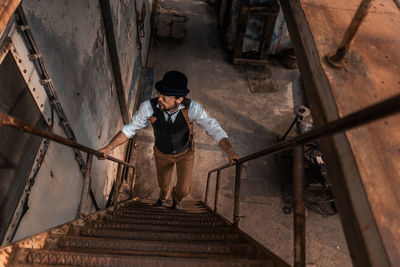 Full length of man standing on staircase