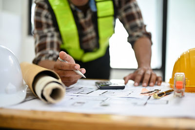 Midsection of man working at table