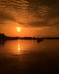 Scenic view of river against orange sky