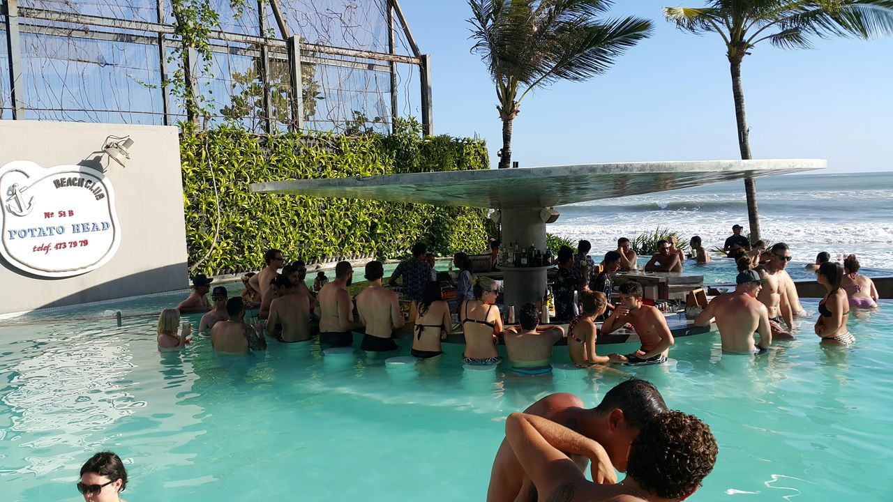 water, large group of people, person, men, lifestyles, sea, leisure activity, mixed age range, beach, togetherness, vacations, enjoyment, day, medium group of people, outdoors, tree, horizon over water, shore, sunlight