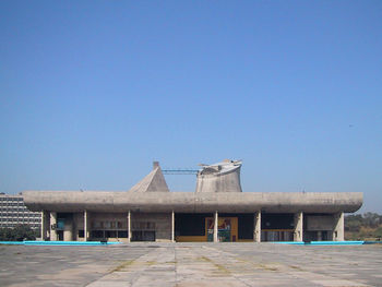 Built structure on beach against clear blue sky