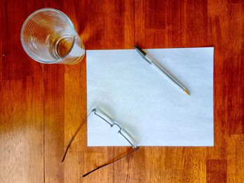 High angle view of a pen with paper on table