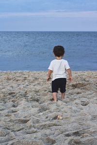 Rear view of boy on beach
