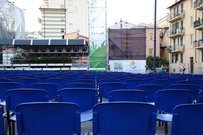 Empty chairs against buildings in city