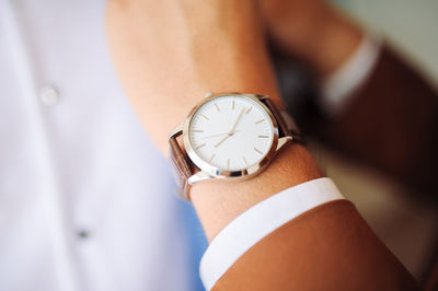 Close-up of hand holding clock