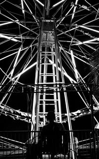 Low angle view of illuminated ferris wheel at night