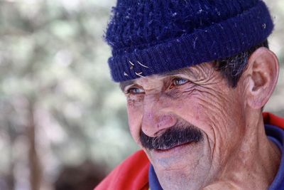 Close-up of man wearing knit hat looking away