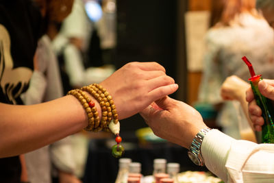 Close-up of people paying at market