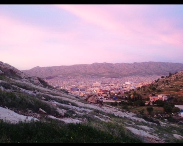 mountain, building exterior, mountain range, sky, built structure, architecture, landscape, house, cloud - sky, residential structure, town, scenics, high angle view, residential district, residential building, townscape, cloud, nature, tranquil scene, beauty in nature