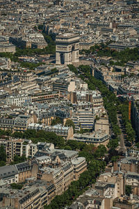 The arc de triomphe and roofs seen from the eiffel tower top in paris. the famous capital of france.