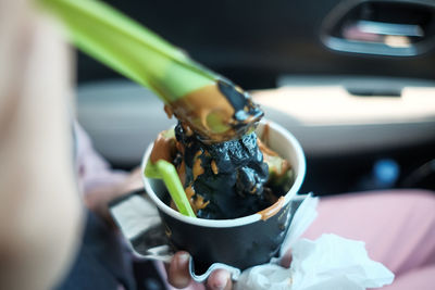 Close-up of hand holding ice cream