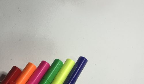 Close-up of colored pencils on white table