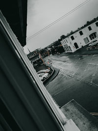 High angle view of road by buildings against sky