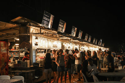 Group of people in restaurant at night