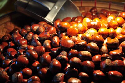 Close-up of chestnuts in wicker basket at market stall